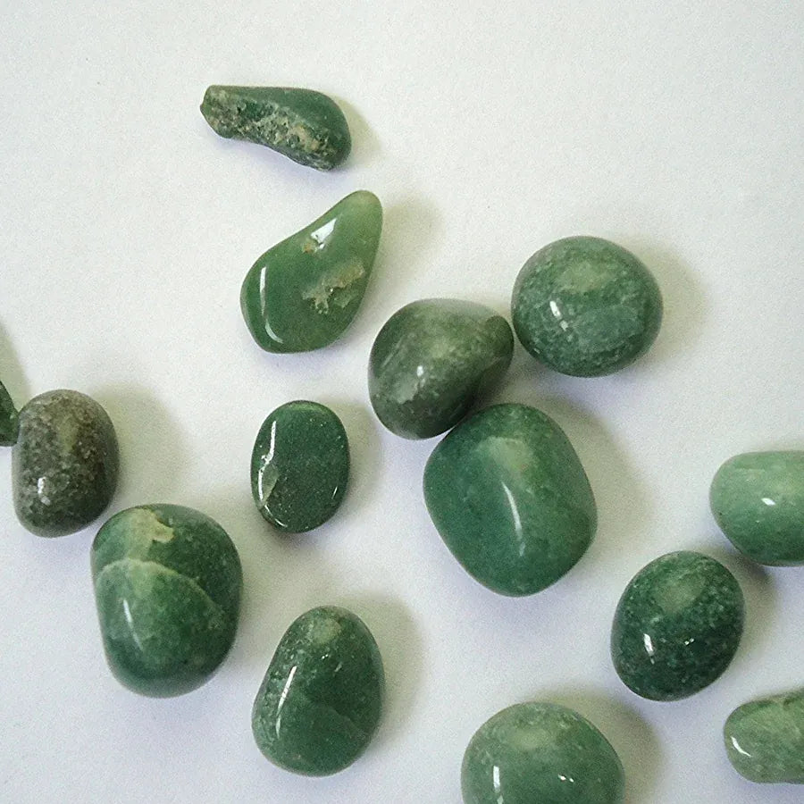 Real green aventurine pebbles photographed on a light background
